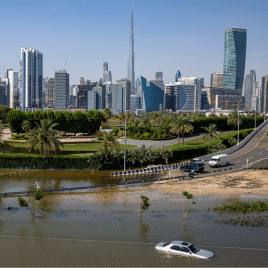 FILE - An abandoned vehicle stands in floodwater caused by heavy rain with the Burj Khalifa, the world's tallest building, seen on the background, in Dubai, United Arab Emirates, on April 18, 2024. Dubai Airports announced on Thursday, May 2, the cancelation and diversion of flights due to unsettled weather conditions in the United Arab Emirates. 